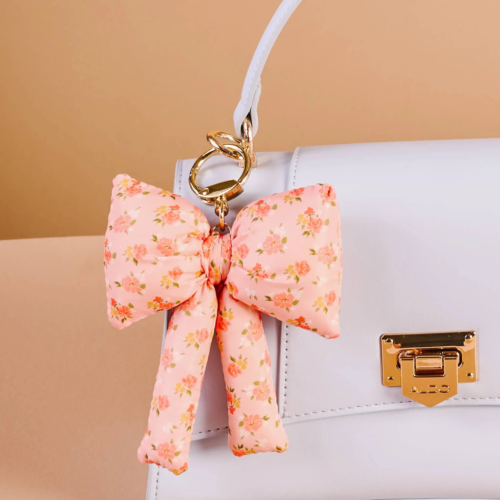 Peachy Petals Puffy Bow Bag Charm in soft pink, floral design, luxury plush fabric accessory for handbags