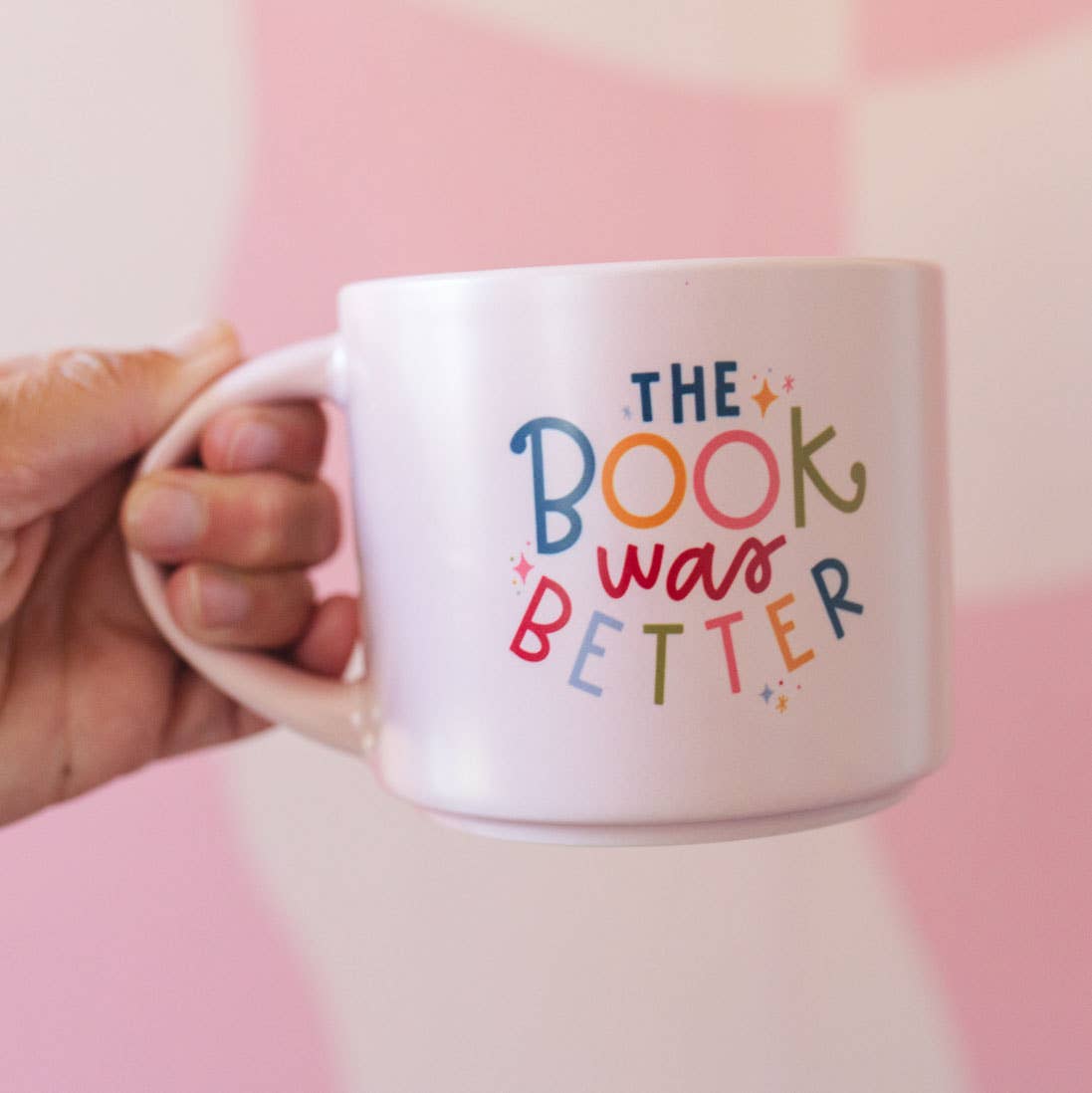 Pink ceramic coffee mug with "The Book Was Better" quote for book lovers, durable and stylish