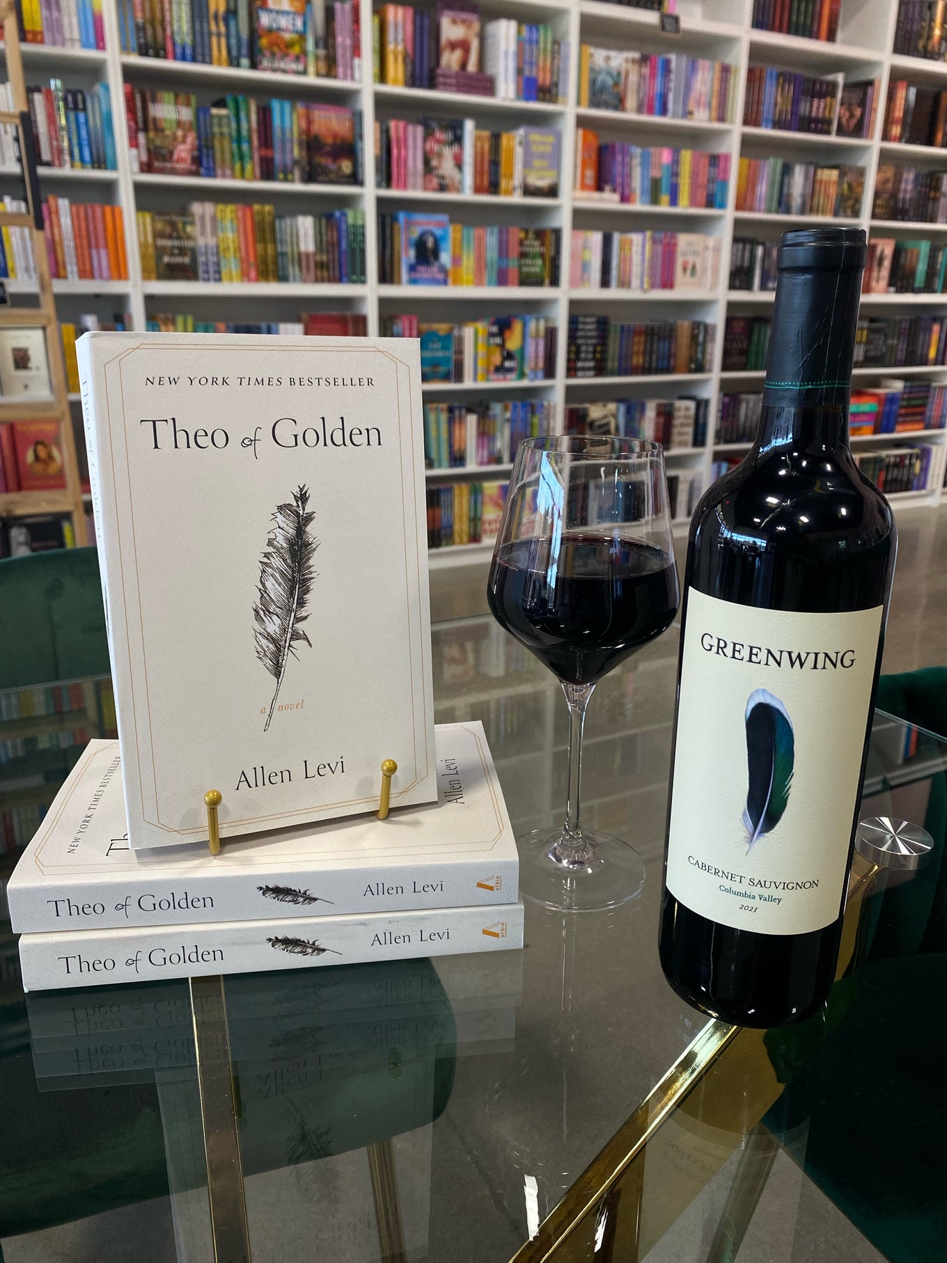 Wine bottle on a glass table with books underneath