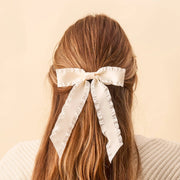 Cream Ruffle Hair Bow for girls, soft fabric with delicate gathered ruffles, easy-to-wear accessory.