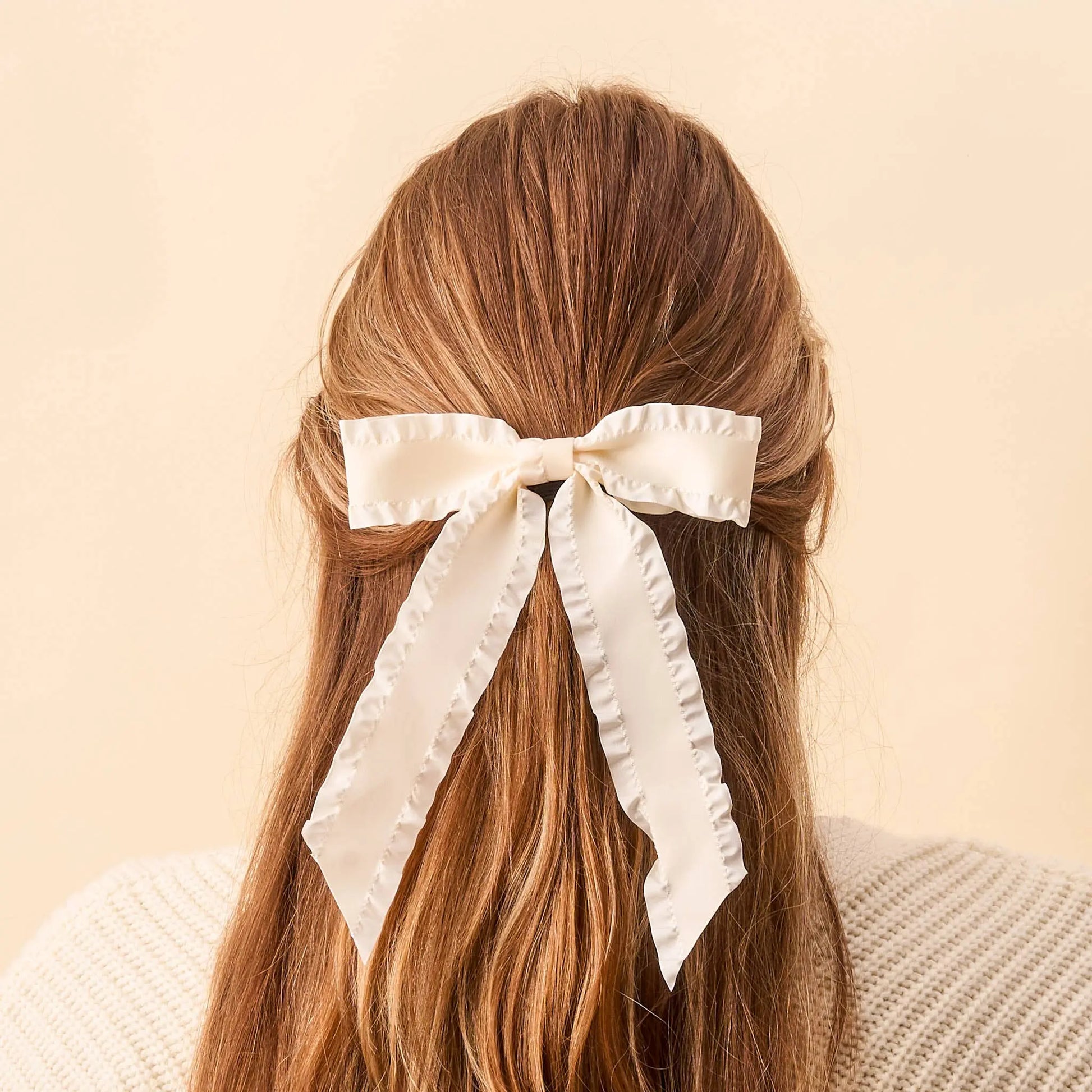 Cream Ruffle Hair Bow for girls, soft fabric with delicate gathered ruffles, easy-to-wear accessory.