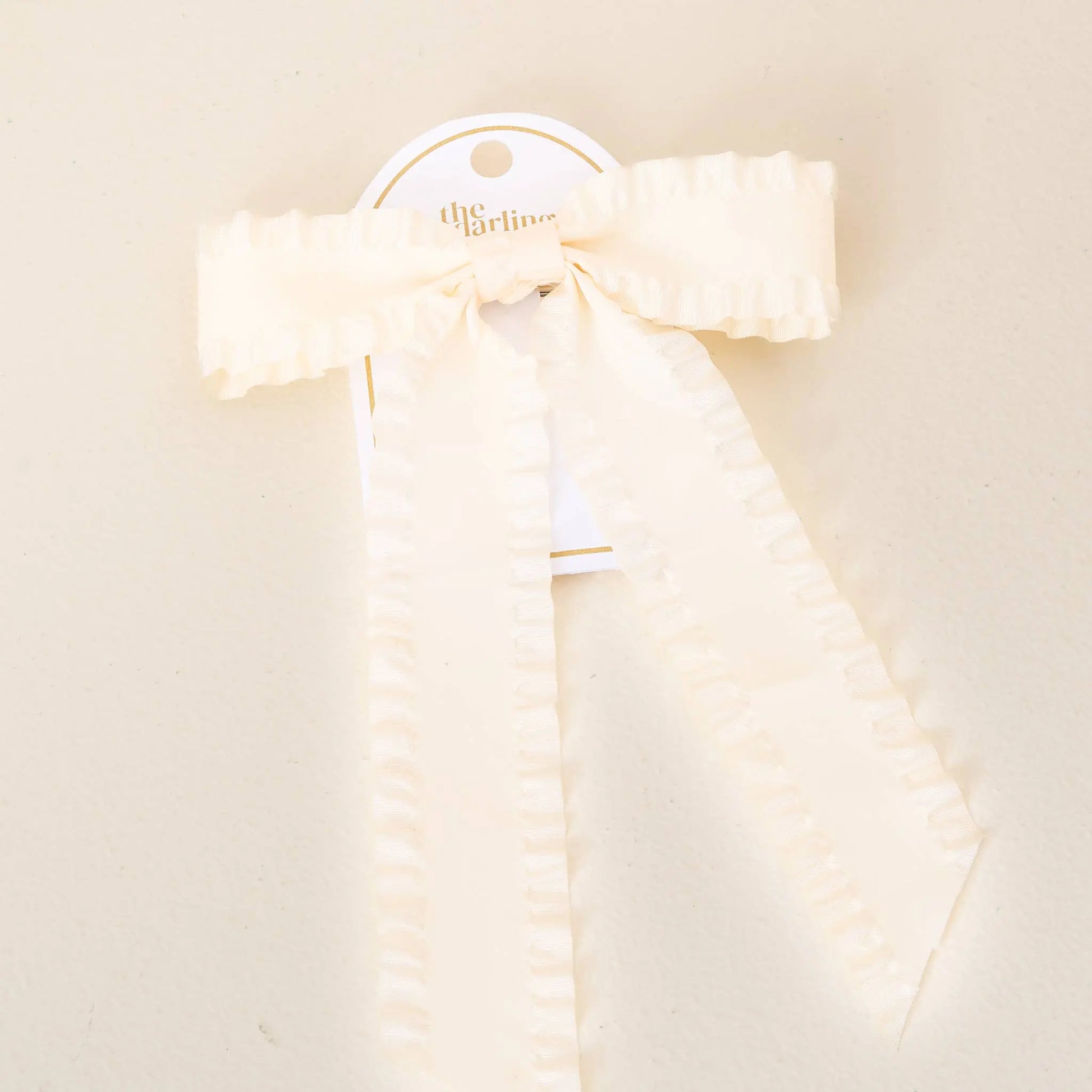 Ruffle Hair Bow Cream - soft cream ribbon with delicate ruffles, a charming girls' hair accessory with clip.